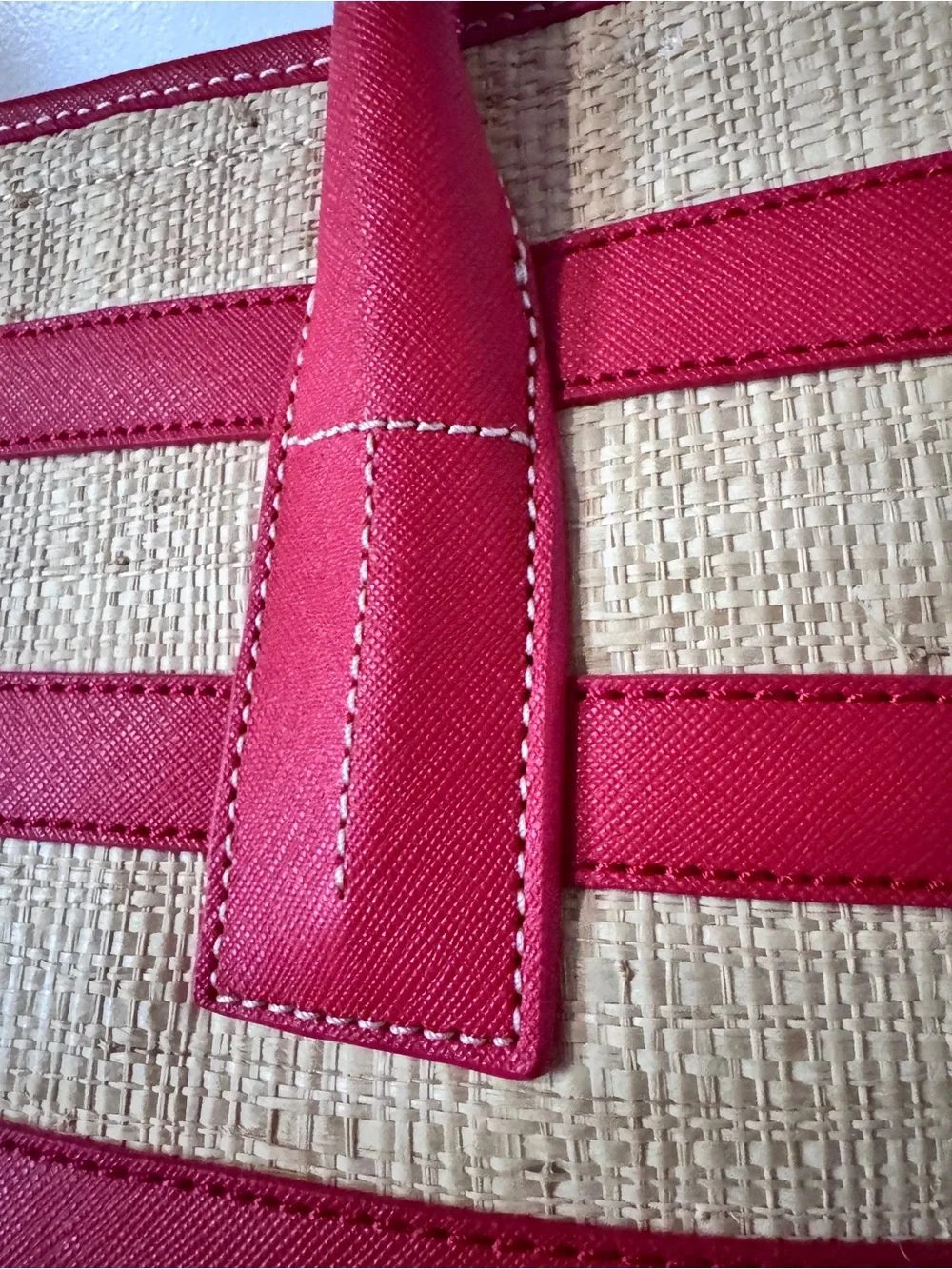 Tory Burch straw tote features vibrant red leather stripes